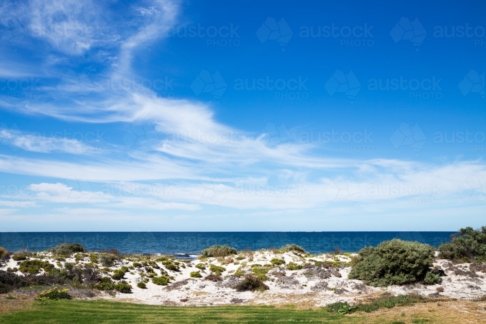 blue sky over calm water and white sand - Australian Stock Image