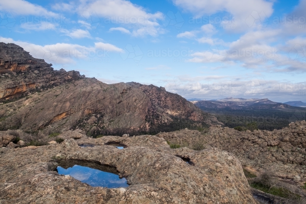 Blue sky reflection in pool among rocks on Mount Stapylton - Australian Stock Image