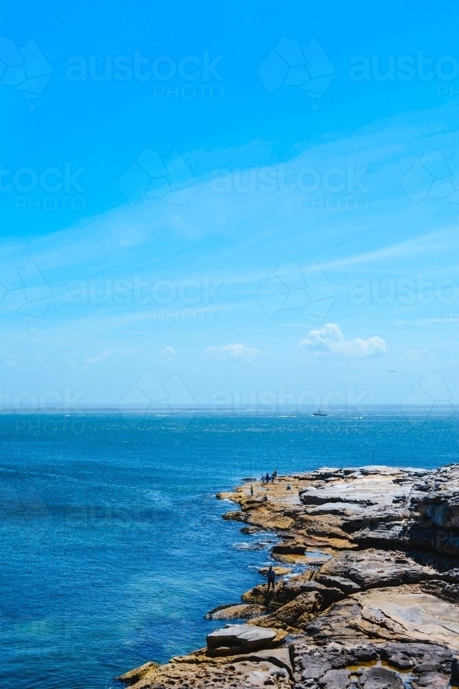 Blue sky with blue ocean and rocky cliffs - Australian Stock Image