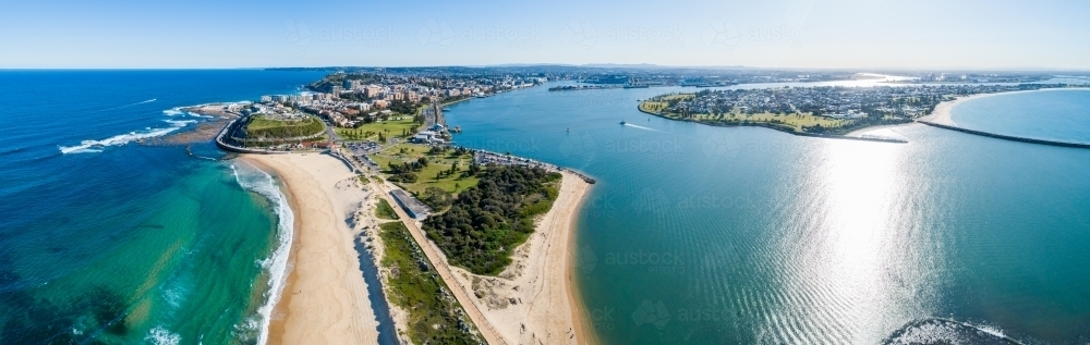 Blue sunlit water where the Hunter River meets the sea in the Newcastle Harbour - Australian Stock Image