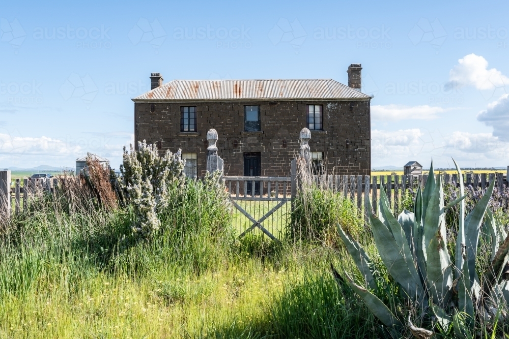 Bluestone free standing house and timber gate - Australian Stock Image