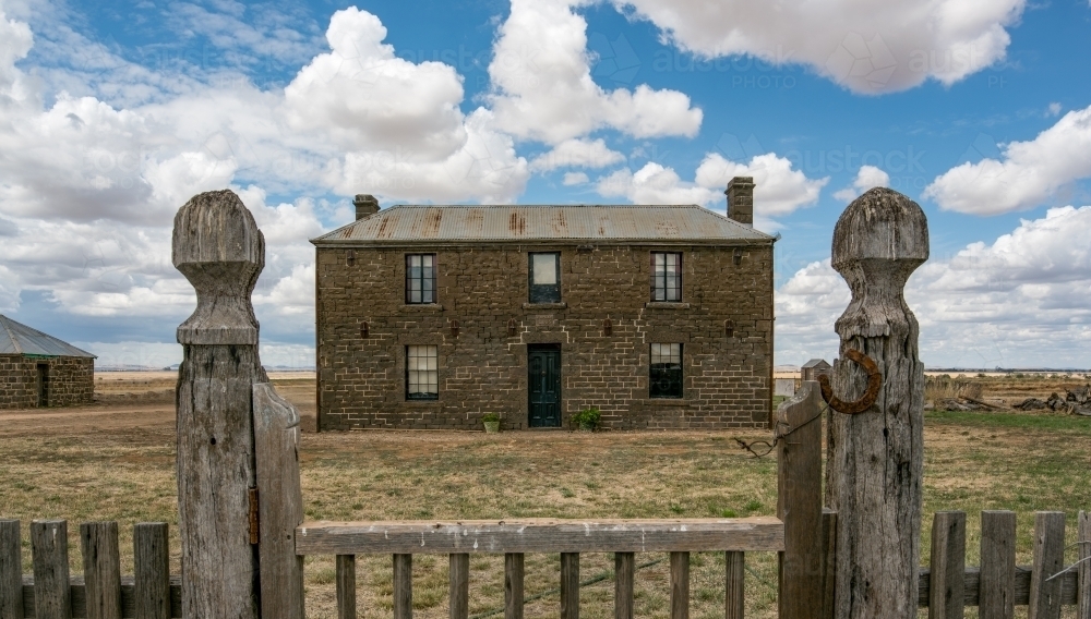 Bluestone house on the plain - Australian Stock Image