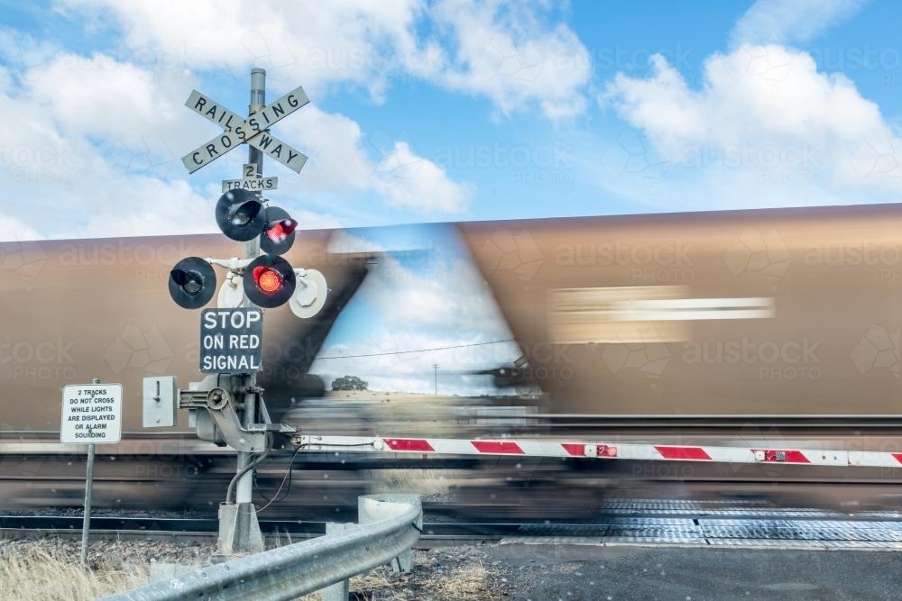 Blurred coal train at railway crossing - Australian Stock Image