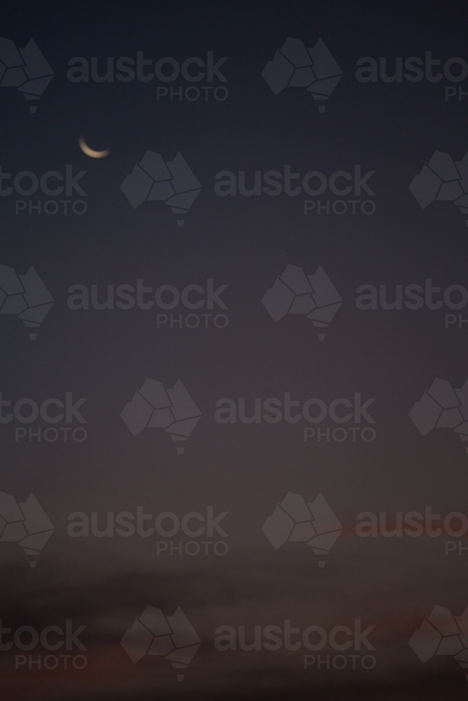 Blurred evening sky with crescent moon - Australian Stock Image