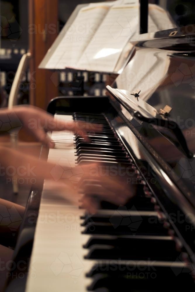 blurred hands on a piano - Australian Stock Image