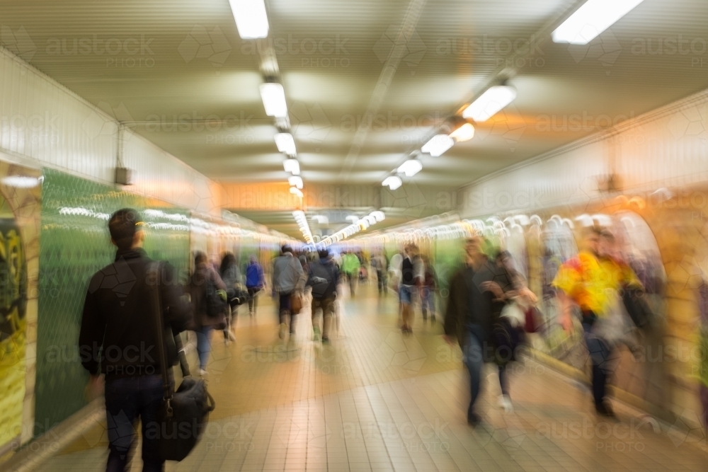 blurry motion abstract of people walking through an underground train station - Australian Stock Image