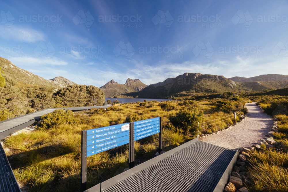 Boardwalk and paths around Dove Lake and Cradle Mountain on a warm autumn afternoon near sunset - Australian Stock Image