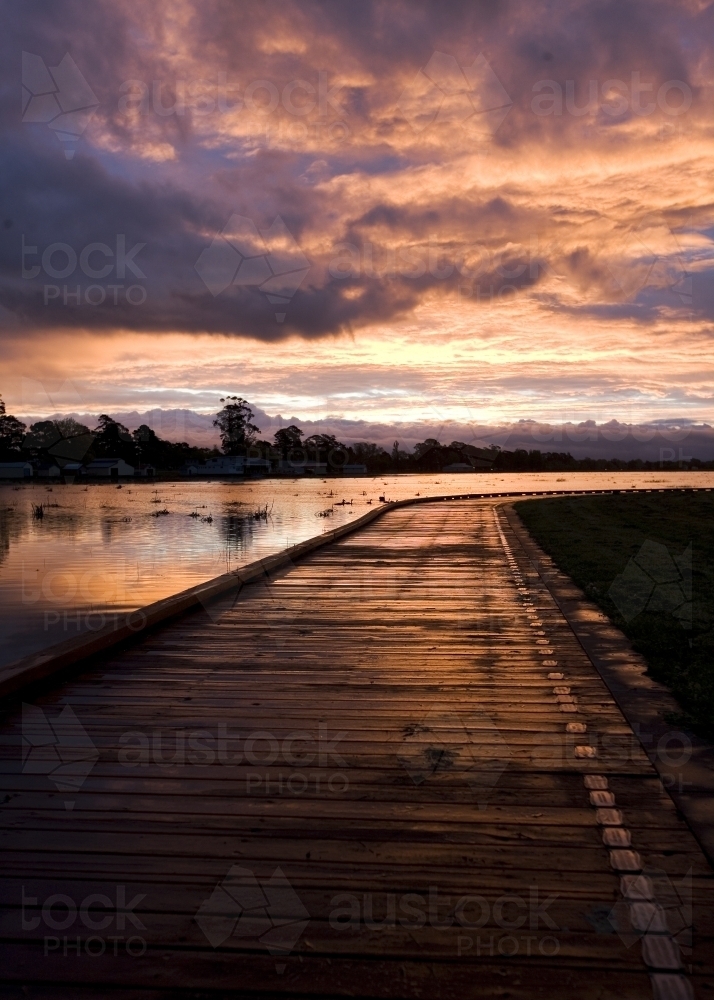 Boardwalk by lake at sunset - Australian Stock Image