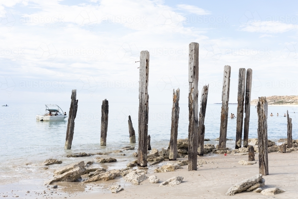 Boat anchored off Port Willunga jetty ruins - Australian Stock Image