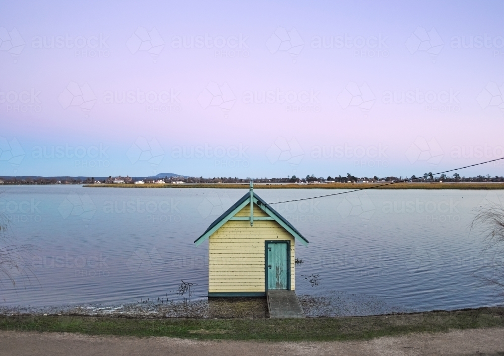 boat shed on a lake in evening light - Australian Stock Image