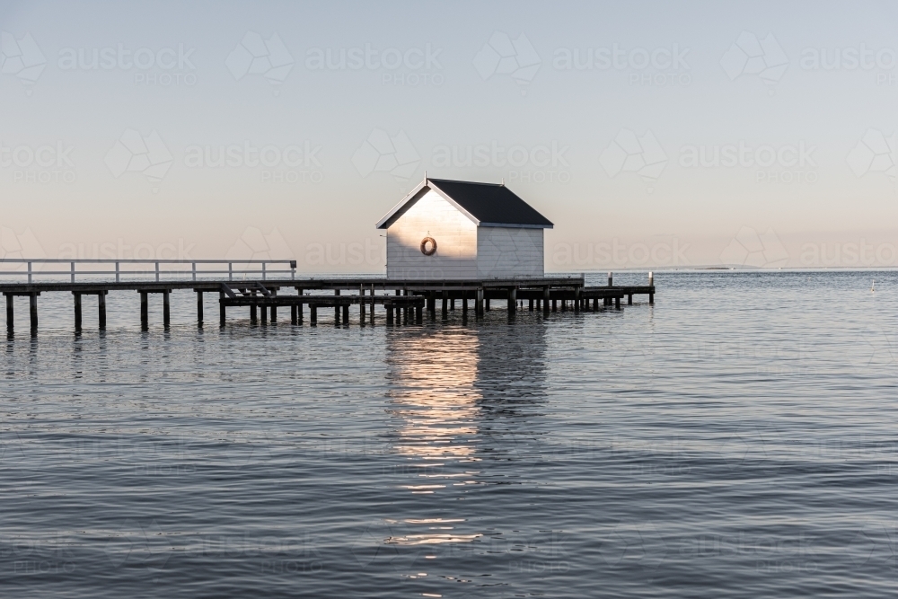 Boat shed on the calm waters at sunset - Australian Stock Image