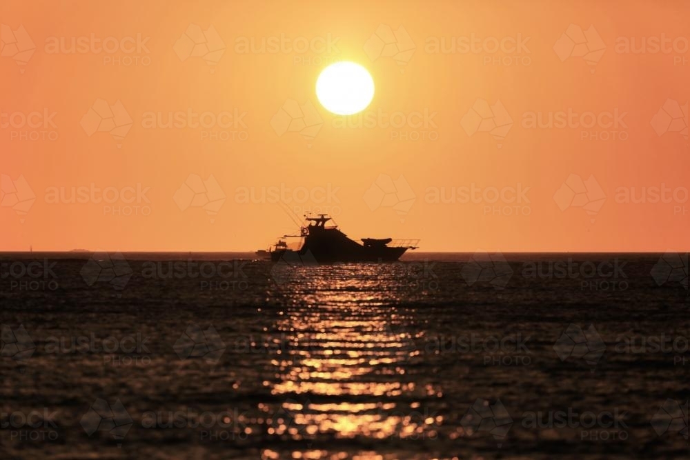 Boat silhouette at sunset - Australian Stock Image