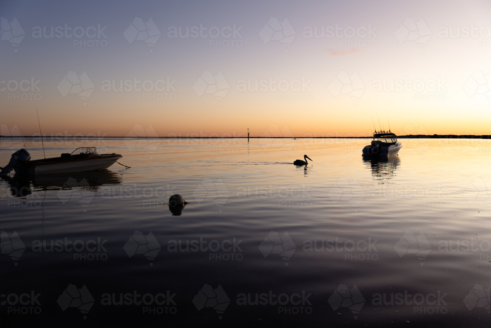 Boats floating on water at Sunrise in Venus Bay : Austockphoto Boats floating on water at Sunrise in Venus Bay - Australian Stock Image