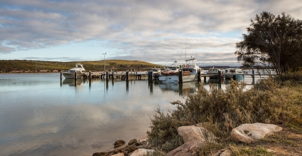 Boats in pens early in the morning in Kalbarri - Australian Stock Image