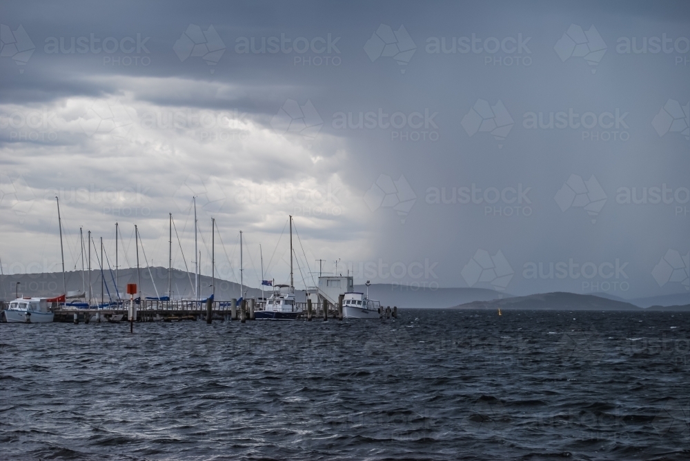Boats moored in stormy weather - Australian Stock Image