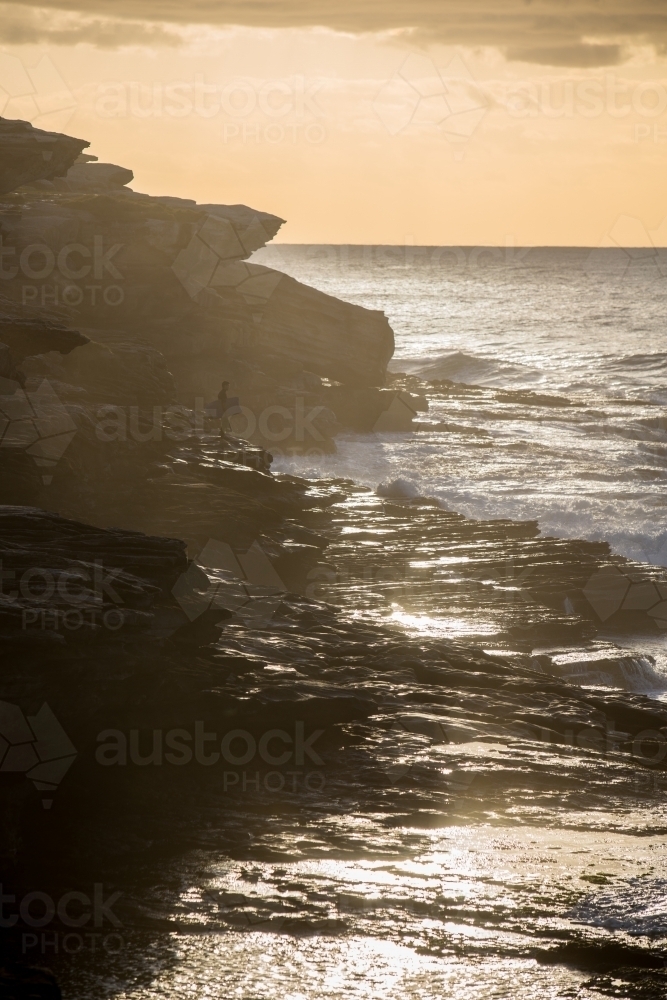 Body boarder on the rocks waiting for his wave - Australian Stock Image