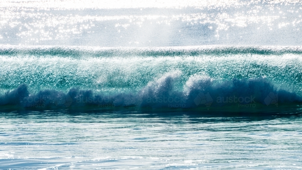 Light sea spray being blown on a perfect barrel - Australian Stock Image