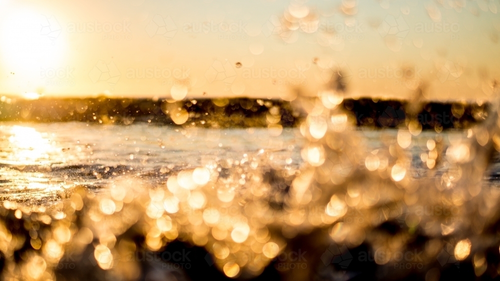 Sparkling golden beach wave bokeh - Australian Stock Image