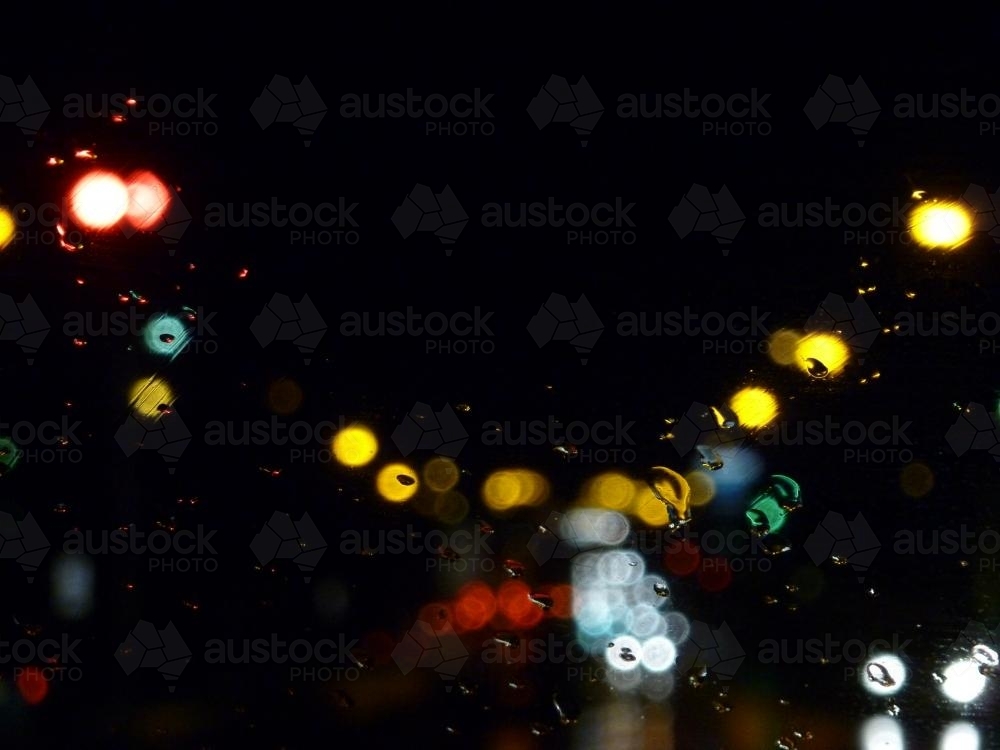 Bokeh lights at night and rain on the window - Australian Stock Image