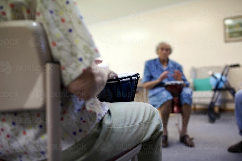 Bongo drumming activity session at retirement village - Australian Stock Image
