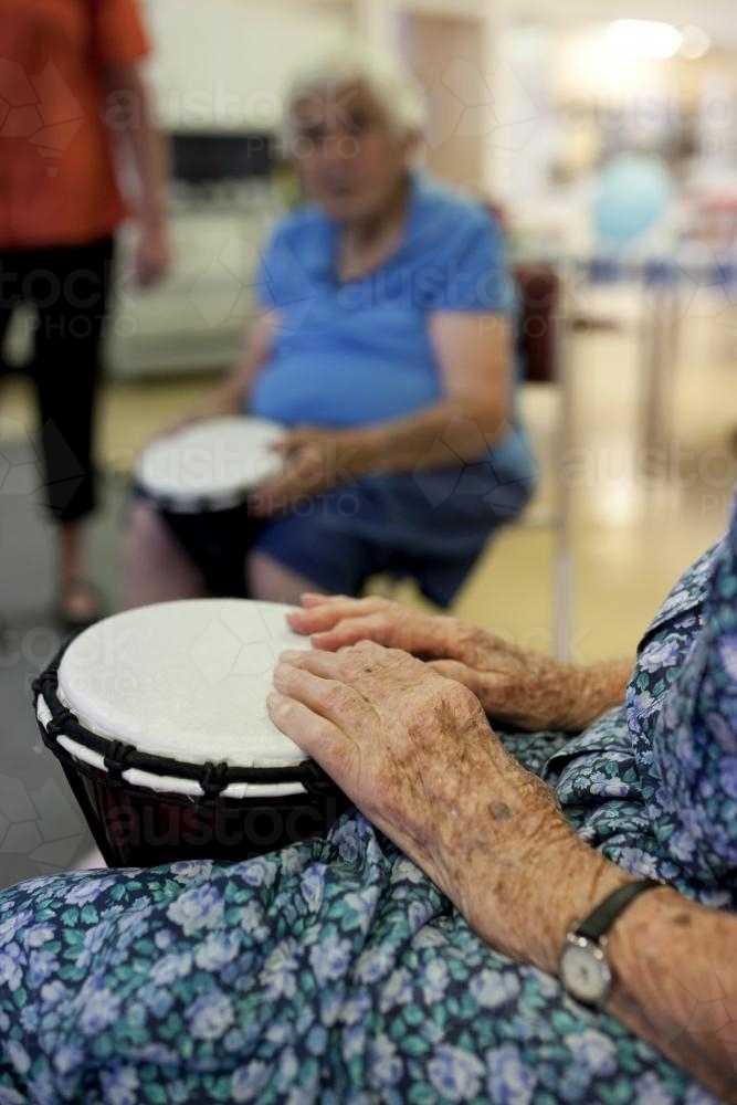 Bongo drumming activity session at retirement village - Australian Stock Image
