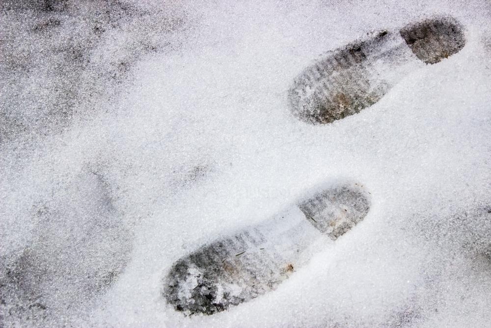 Boot prints in shallow snow - Australian Stock Image