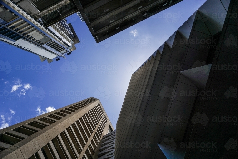 bottom shot of buildings and skyscrapers with blue skies on a sunny day - Australian Stock Image
