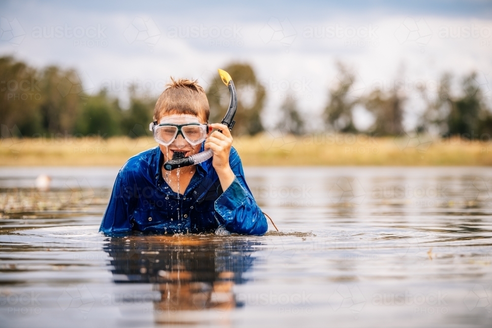 Boy above  water with snorkel on - Australian Stock Image