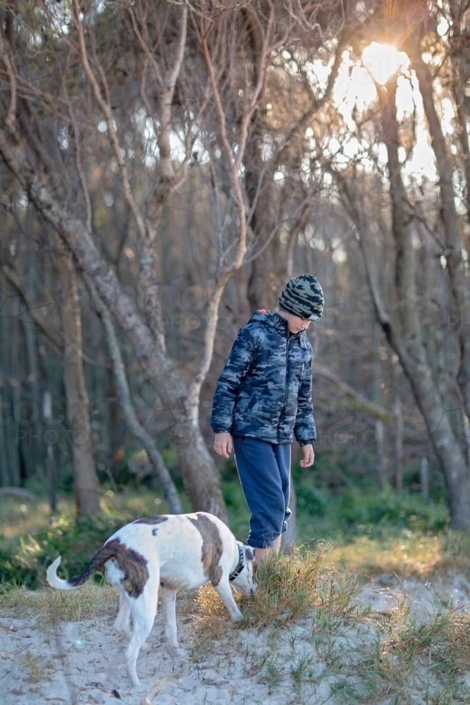 Boy and dog explore the remote coast of Queensland - Australian Stock Image