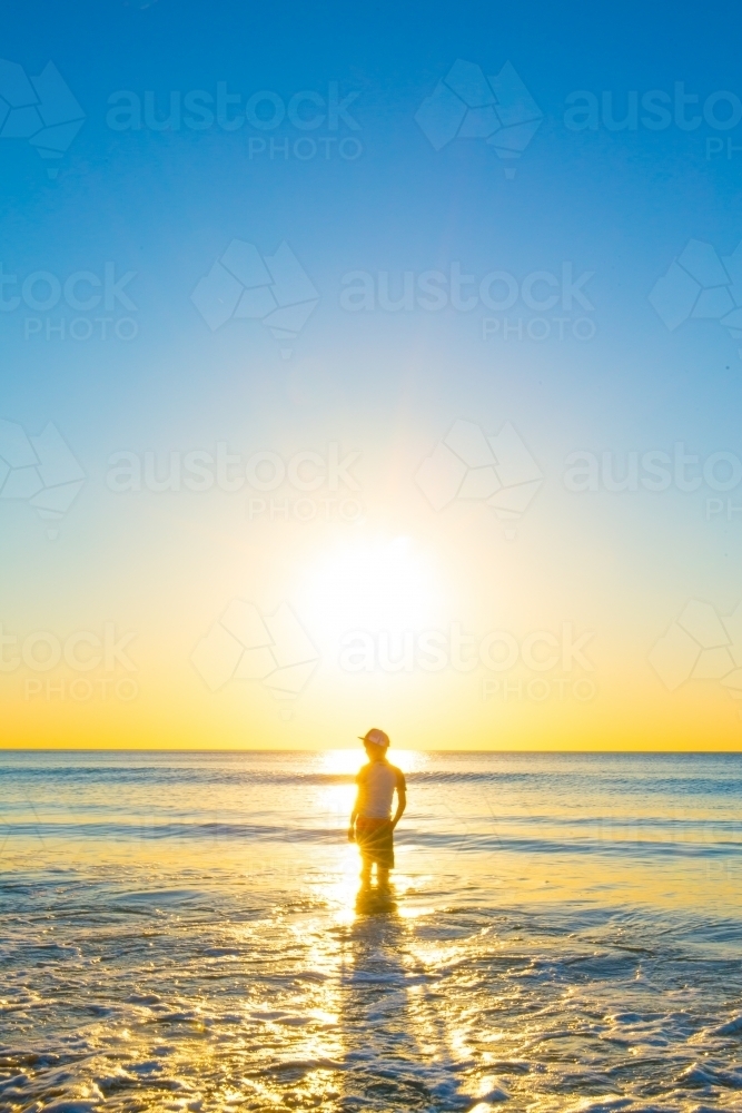 Boy at the beach at sunset, Port Willunga, Fleurieu Peninsula, South Australia - Australian Stock Image