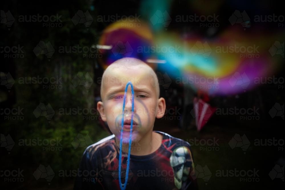 Boy blowing bubbles - Australian Stock Image