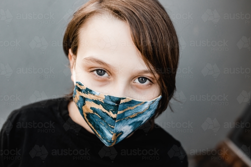 boy child wearing fabric masks during the corona COVID-19 pandemic, masks are now compulsory. - Australian Stock Image