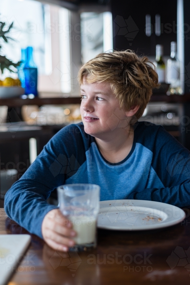 Image of boy eating breakfast - Austockphoto