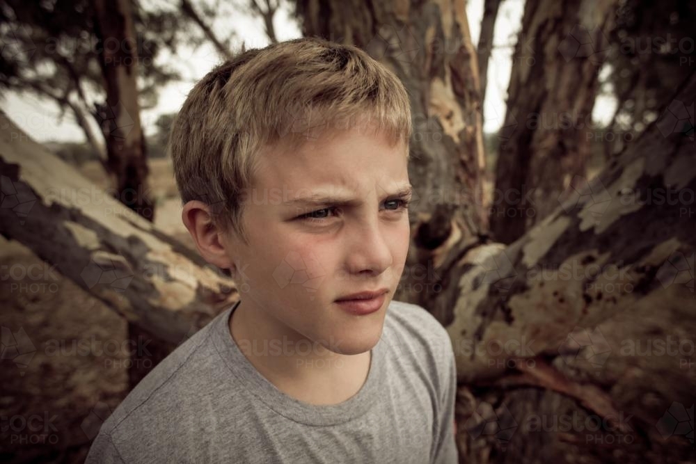 Boy in the bush - not smiling - Australian Stock Image