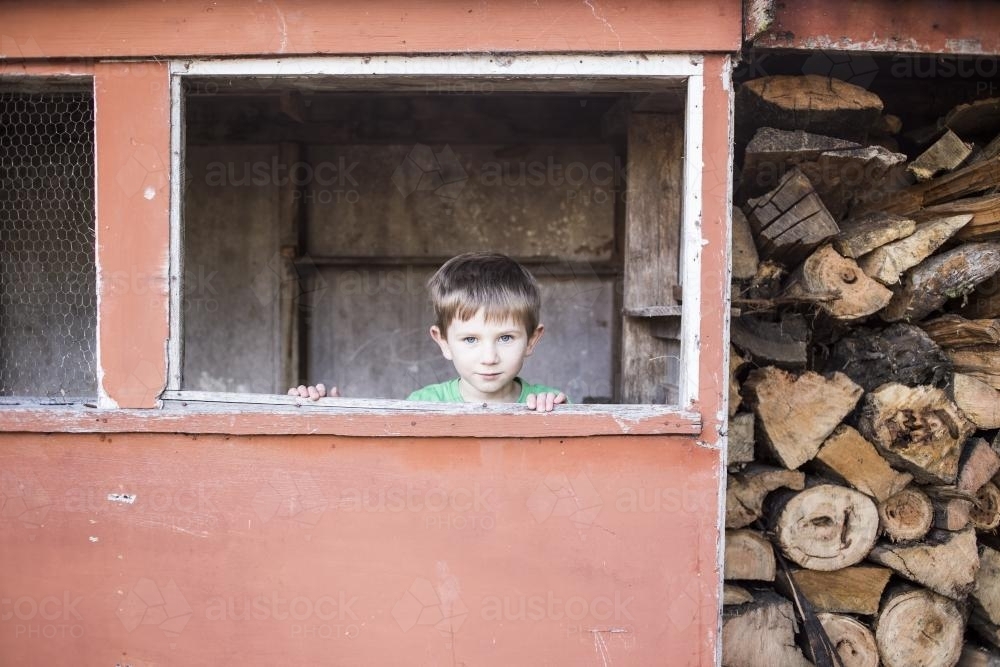 Boy in wood shed - Australian Stock Image