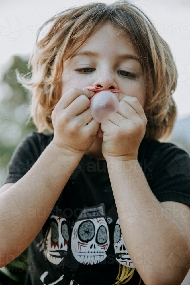 Boy learning to blow bubbles - Australian Stock Image