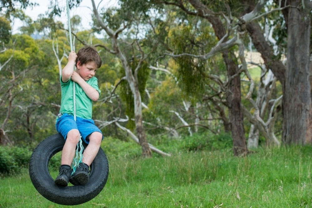 Boy playing in natural bush - Australian Stock Image
