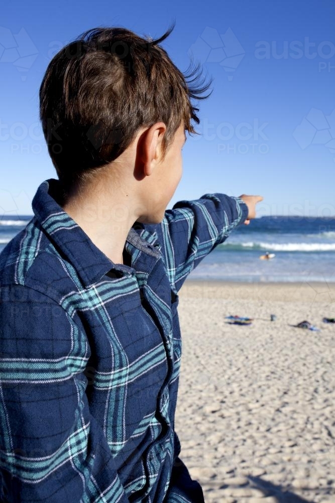 Boy pointing at the ocean - Australian Stock Image