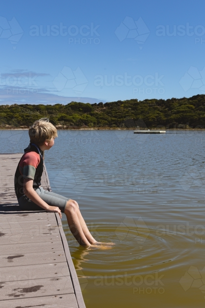 Boy sitting with legs in the Pool of Siloam - Australian Stock Image