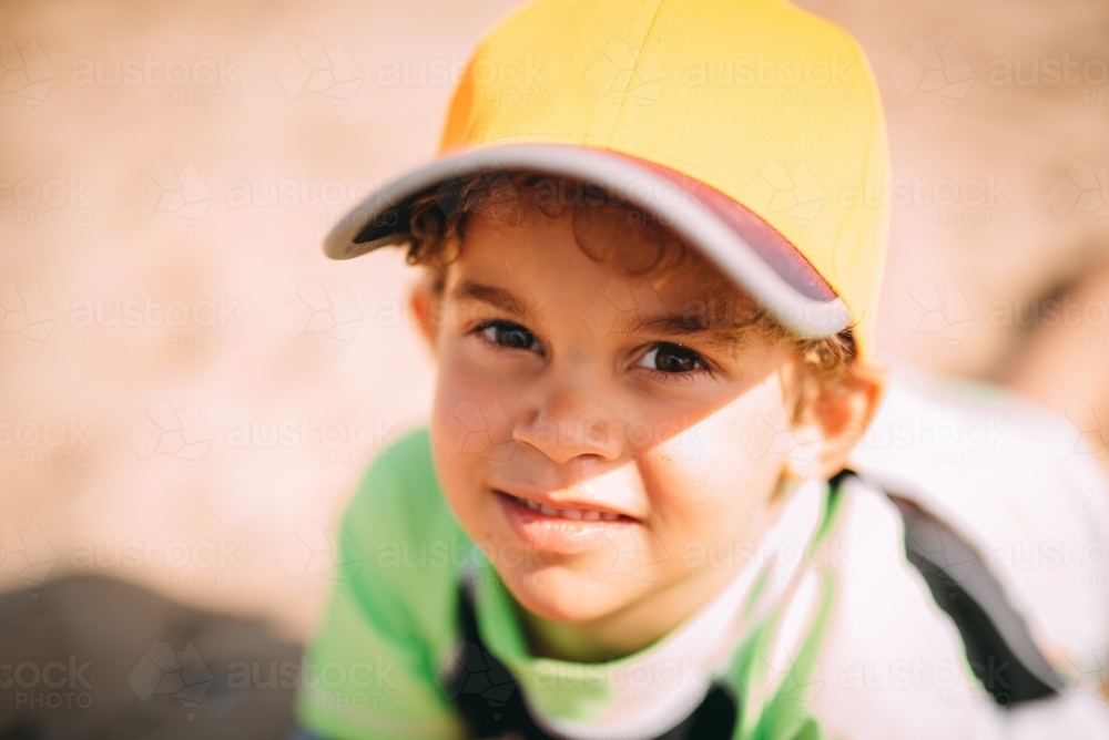 Boy smiling up at the camera - Australian Stock Image