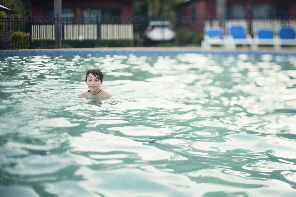 Boy swimming in pool - Australian Stock Image