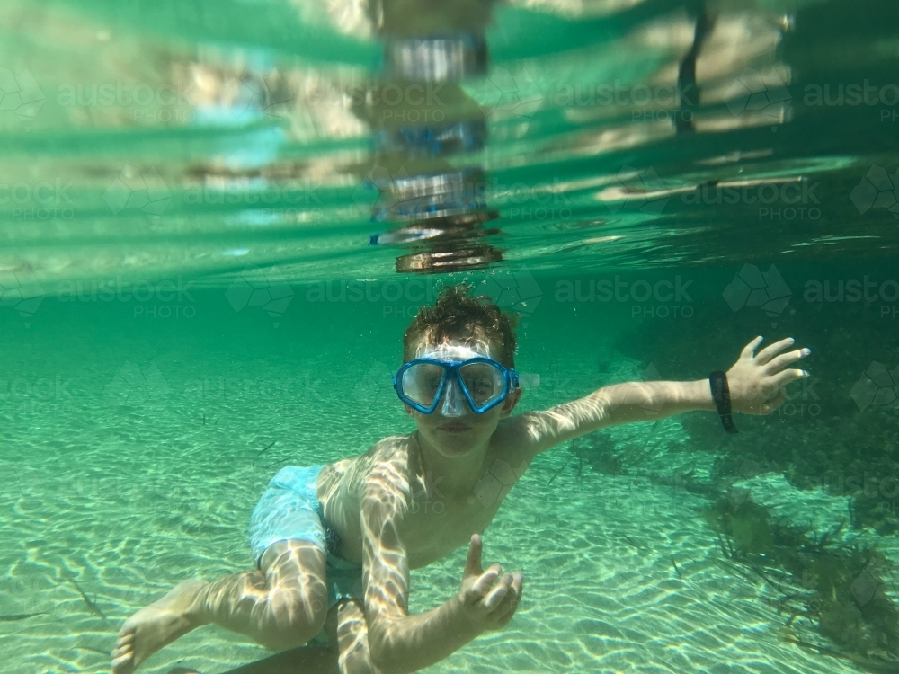 Boy underwater wearing snorkeling mask - Australian Stock Image
