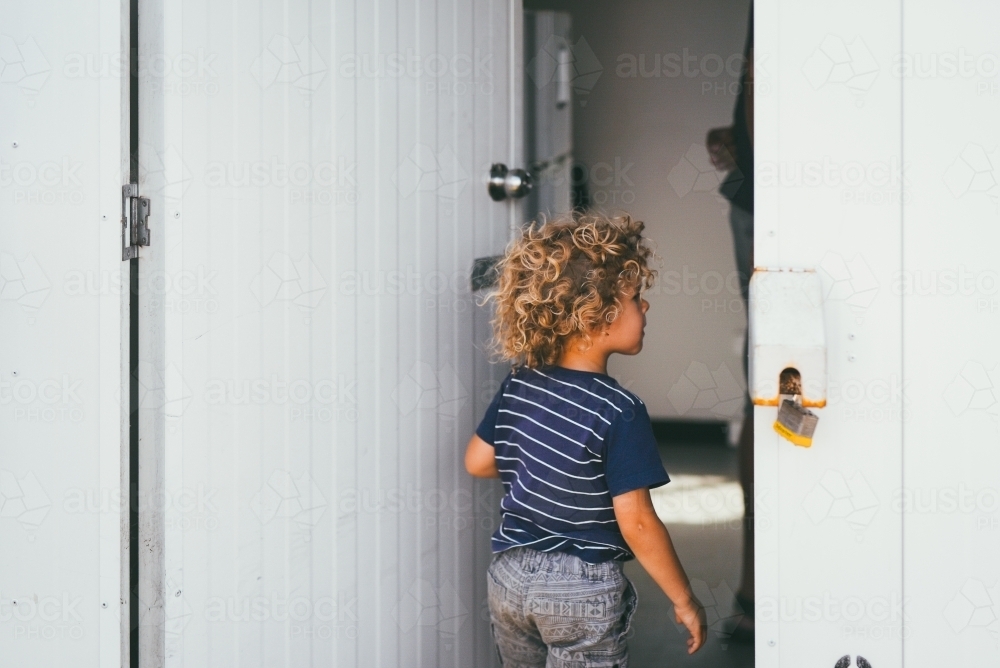 Image of Boy walking into a room Austockphoto