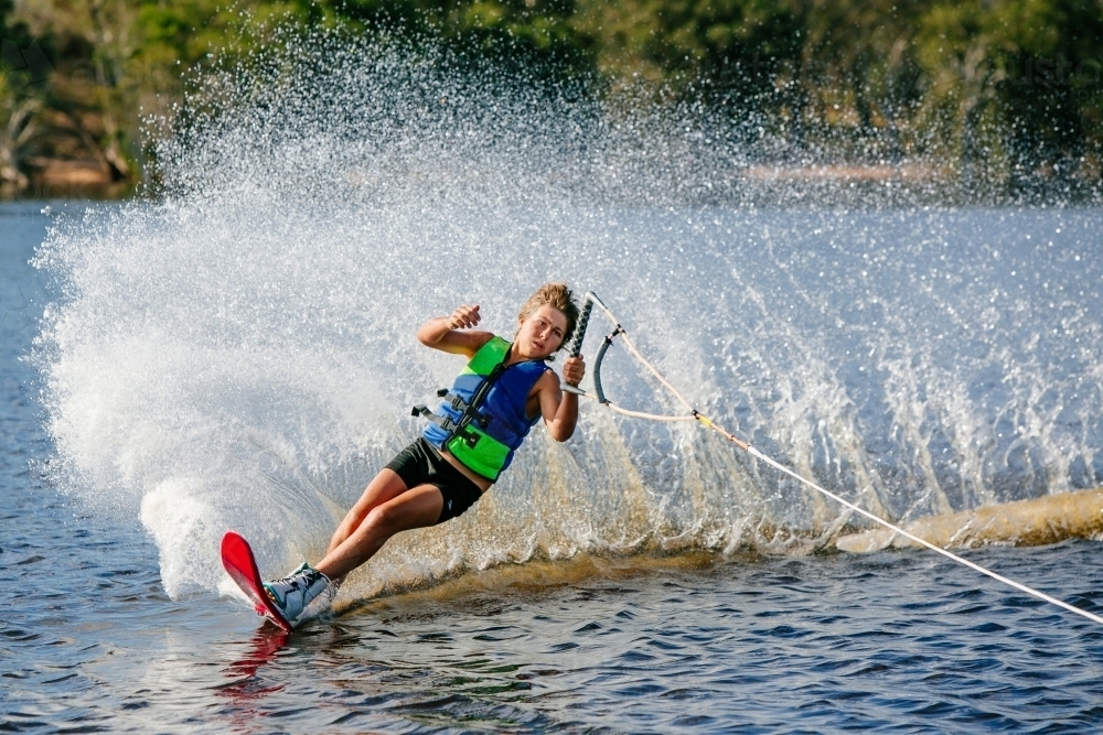Boy water skiing on lake - Australian Stock Image