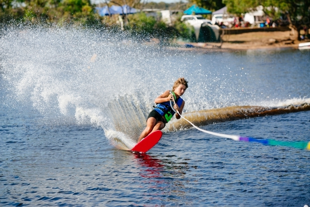 Boy water skiing on lake - Australian Stock Image