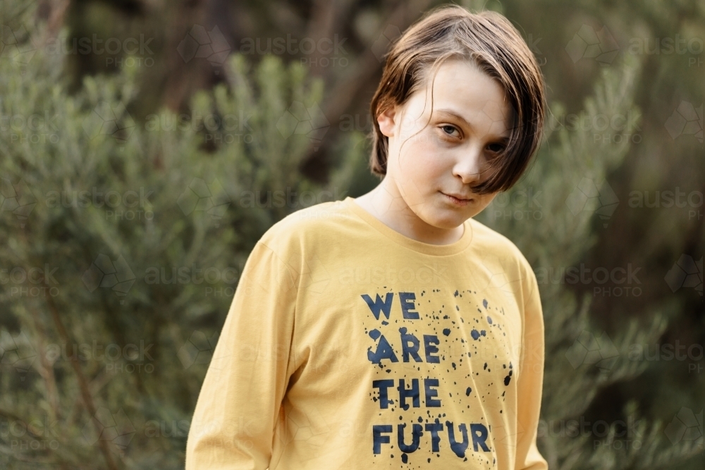 Boy wearing a generic yellow T-shirt that says we are the future - Australian Stock Image