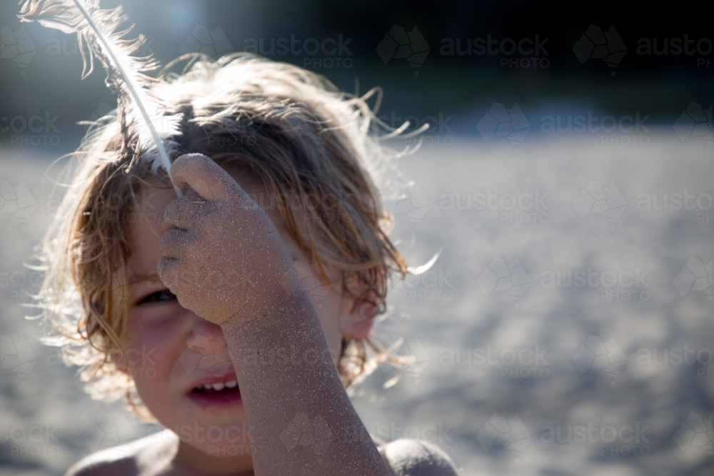 Boy with feather - Australian Stock Image