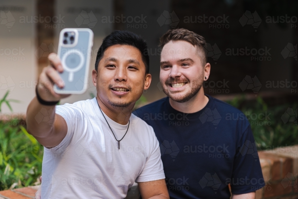 boyfriends taking selfies - Australian Stock Image