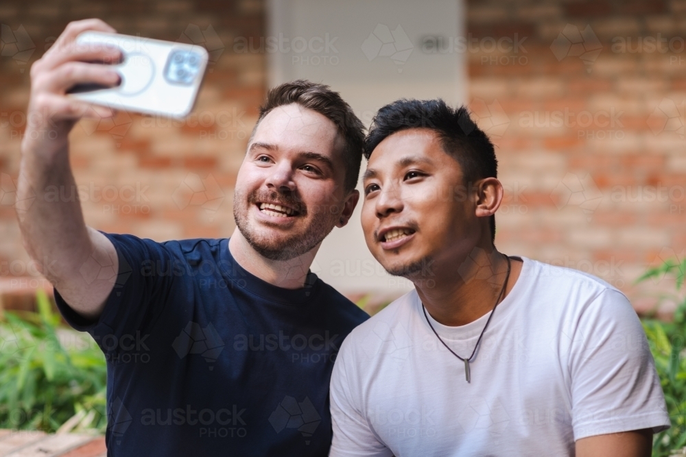 boyfriends taking selfies - Australian Stock Image