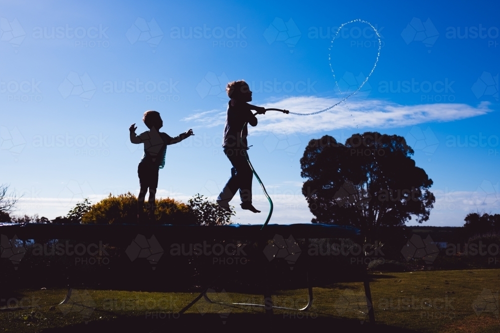 boys and backyard water play - Australian Stock Image